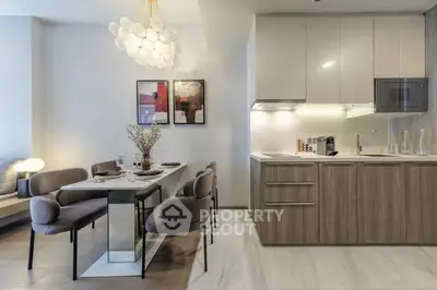 Modern kitchen and dining area with sleek design and elegant lighting
