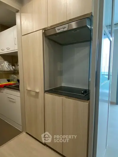 Modern kitchen with sleek cabinetry and built-in appliances in a compact layout.