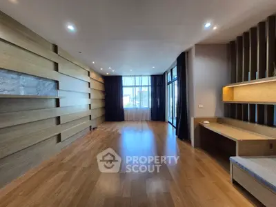 Spacious modern living room with wooden flooring and large windows