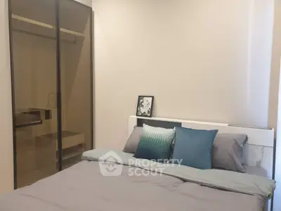 Modern bedroom with sleek design and cozy bedding in a stylish apartment.