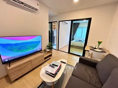 Modern living room with TV and cozy bedroom view