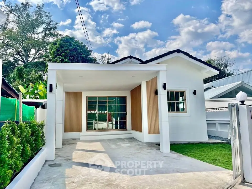 Charming single-story house with modern facade and spacious driveway