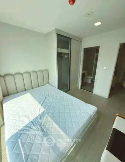 Modern bedroom with large window and minimalist design
