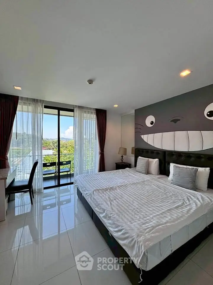 Spacious bedroom with large windows and unique wall art, offering a serene view and modern furnishings.