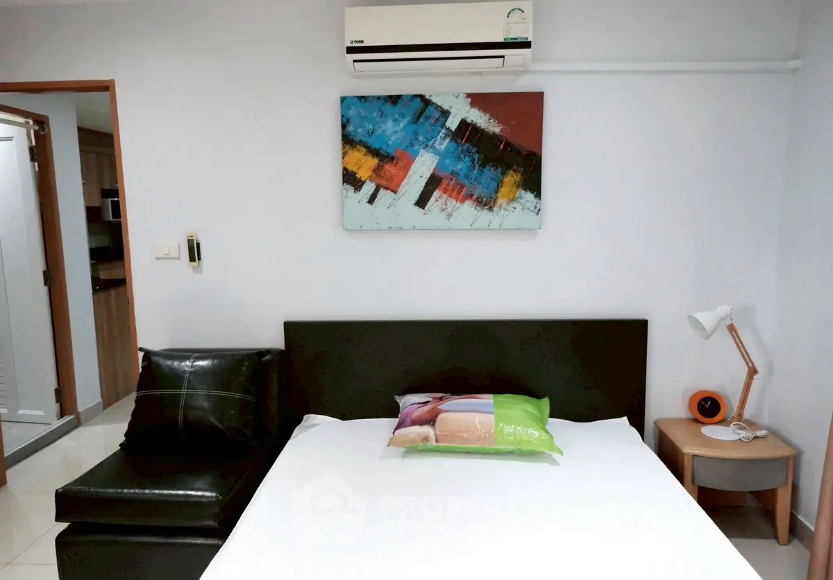 Modern bedroom with stylish decor and air conditioning in a cozy apartment.