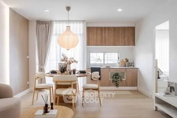 Modern open-layout kitchen and dining area with natural light and stylish decor.