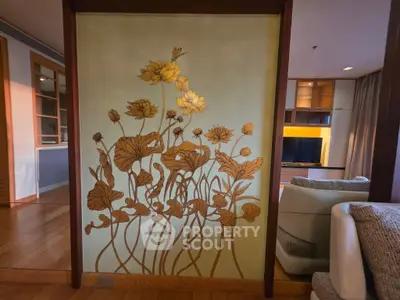 Elegant living room with artistic floral wall design and modern furnishings