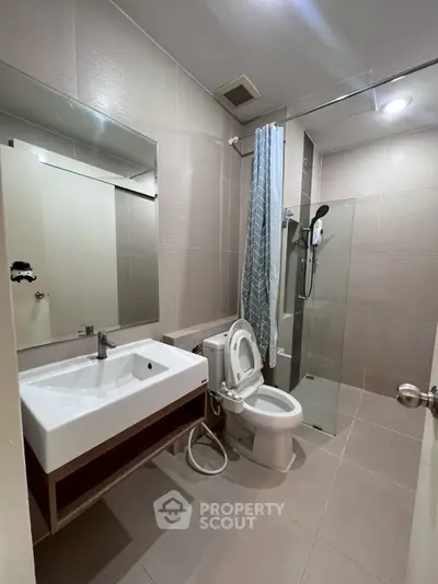 Modern bathroom with sleek fixtures and glass shower enclosure