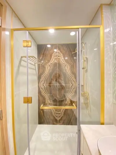 Luxurious bathroom with elegant marble shower and gold accents