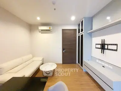Modern living room with sleek furniture and wall-mounted TV setup