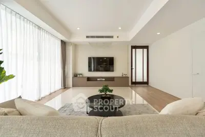 Spacious modern living room with large windows and elegant decor