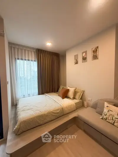 Cozy bedroom with modern decor and large window offering city view