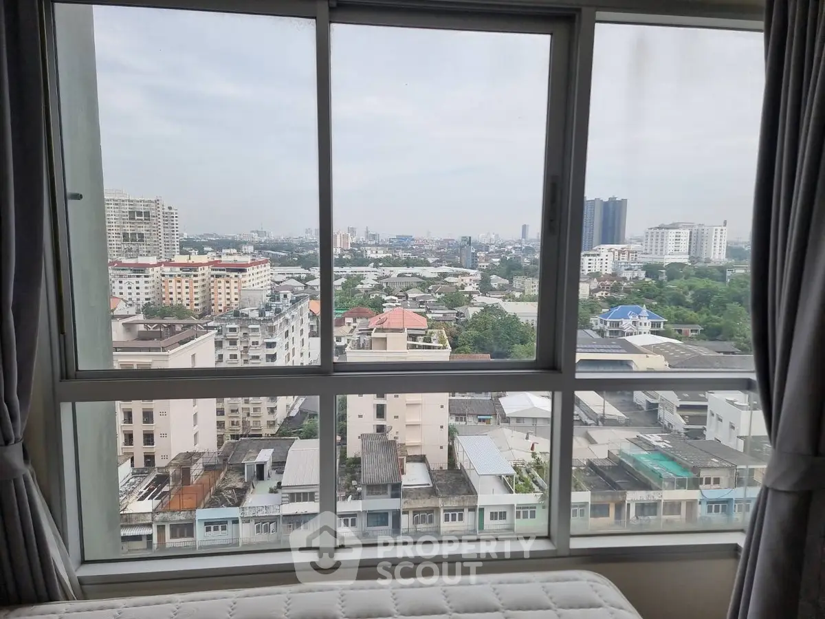 Stunning cityscape view from a high-rise apartment window, showcasing urban living.