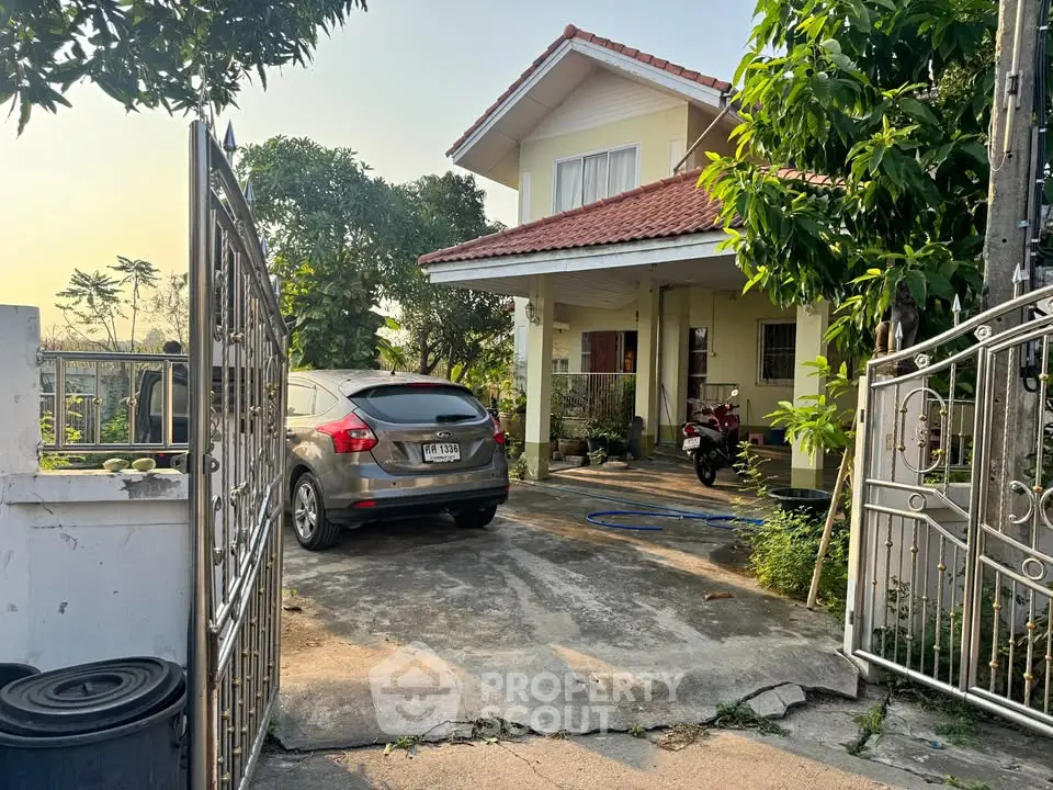 Charming two-story house with driveway and lush greenery, perfect for family living.