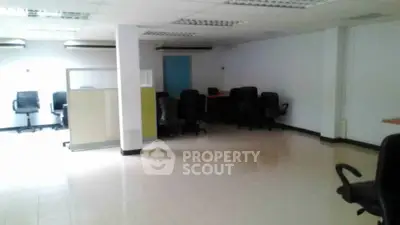 Spacious office space with modern chairs and ample lighting, ideal for business operations.