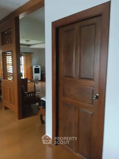 Spacious living area with wooden accents and modern furniture