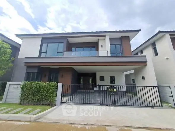 Modern two-story house with sleek design and spacious balcony, recently sold.