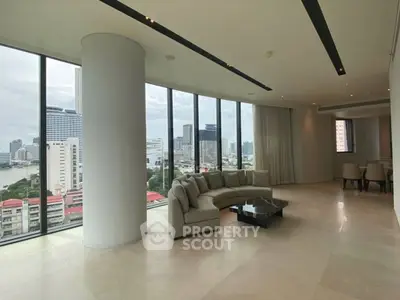 Luxurious corner unit living room with panoramic city views and modern furnishings.