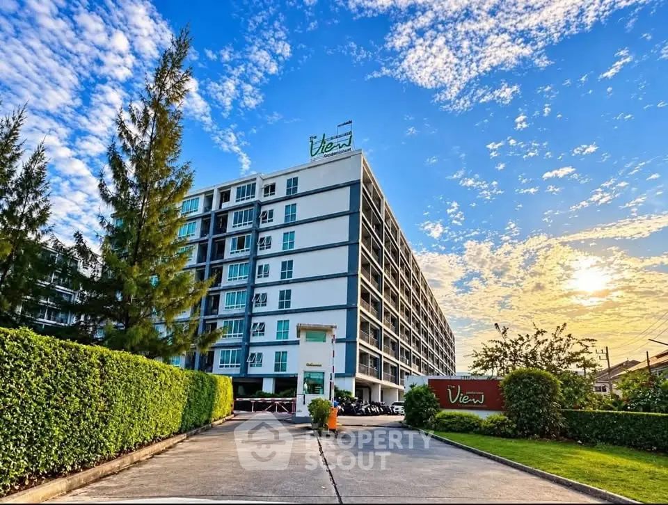 Modern apartment building with lush greenery and vibrant sky view