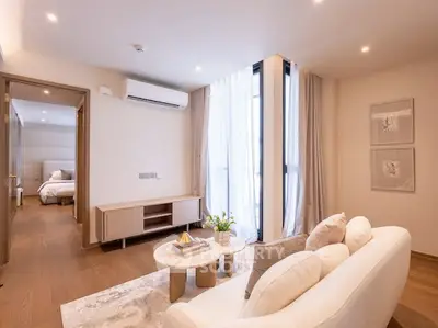 Modern living room with elegant decor and natural light, featuring a cozy sofa and stylish coffee table.
