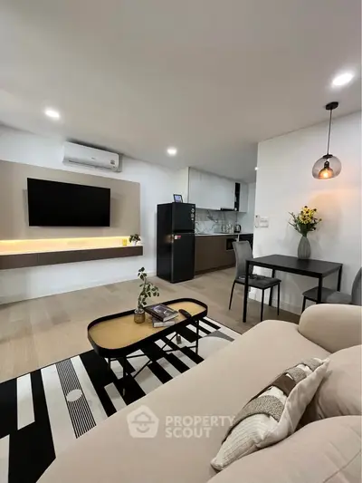 Modern living room with sleek furniture and open kitchen layout, perfect for contemporary living.