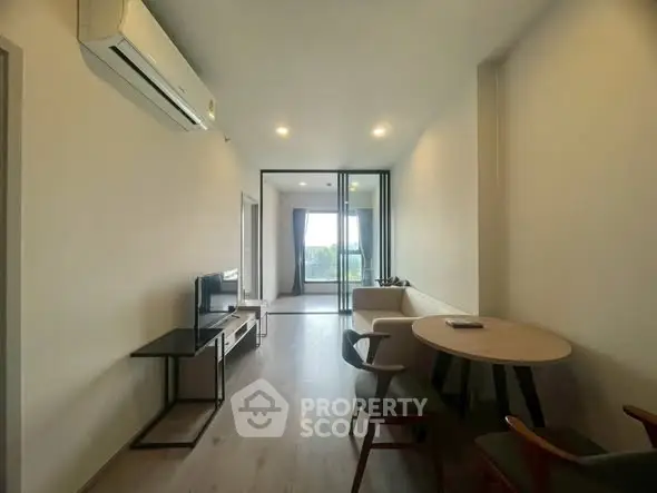 Modern living room with sleek furniture and large window view