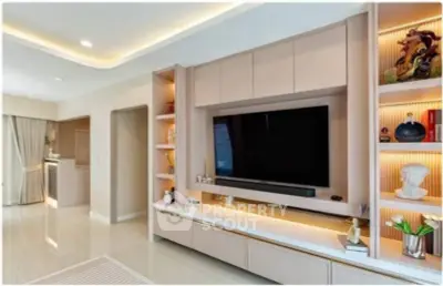 Modern living room with built-in entertainment center and elegant lighting