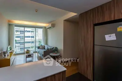 Modern living room with balcony view and sleek kitchen design