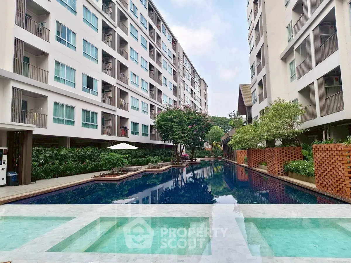 Luxurious condominium with stunning pool and lush garden view
