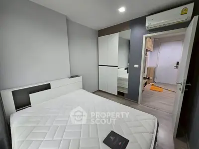 Modern bedroom with sleek design and built-in wardrobe in a stylish apartment.