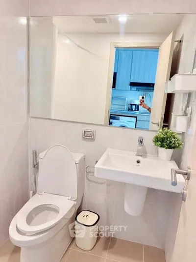 Modern bathroom with sleek fixtures and large mirror