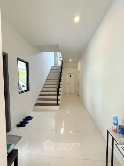 Modern interior hallway with sleek staircase and minimalist design