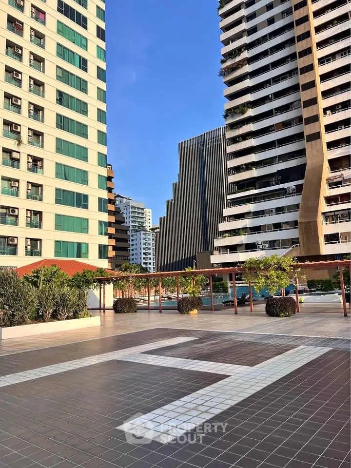 Stunning urban rooftop with modern architecture and lush greenery, perfect for relaxation and city views.