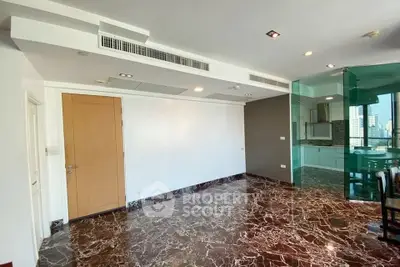Spacious modern living room with marble flooring and glass partition in luxury apartment.