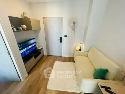 Cozy living room with modern decor, featuring a sleek TV unit and comfortable sofa, perfect for relaxation.