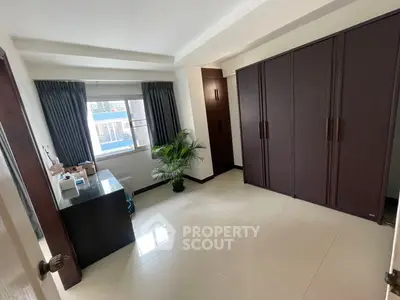 Spacious bedroom with large wardrobe and natural light
