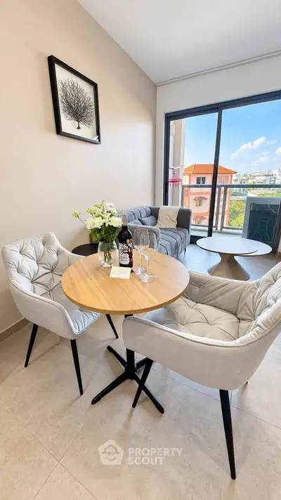 Chic modern living room with stylish furniture and balcony view, perfect for urban living.