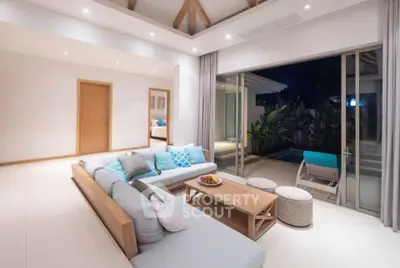 Luxurious living room with pool view and modern decor, perfect for relaxation.