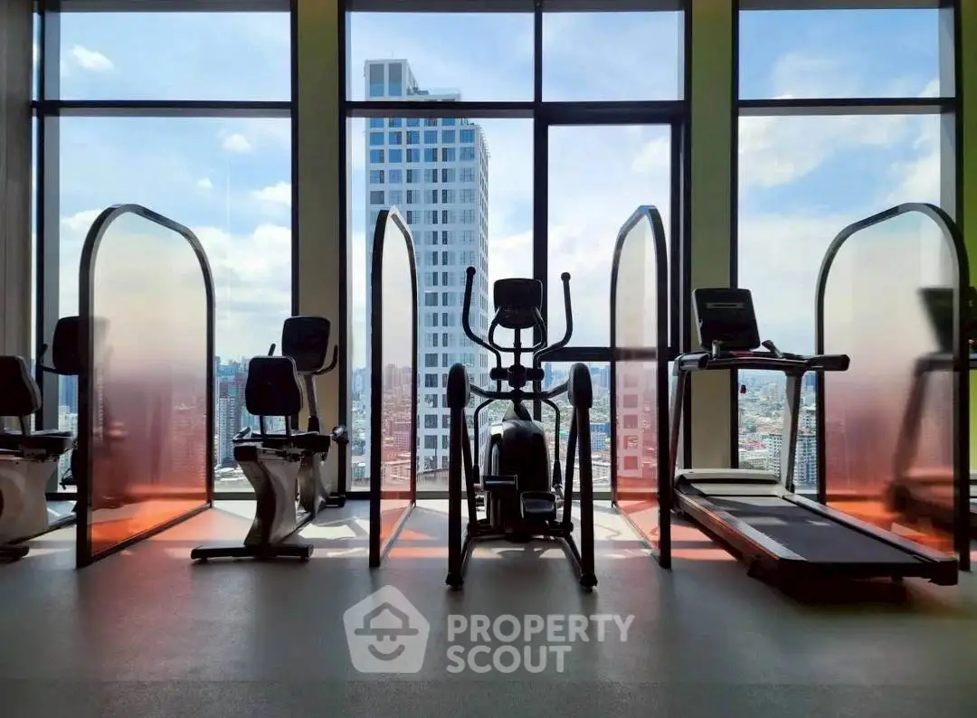 Modern gym with city view and exercise equipment in high-rise building