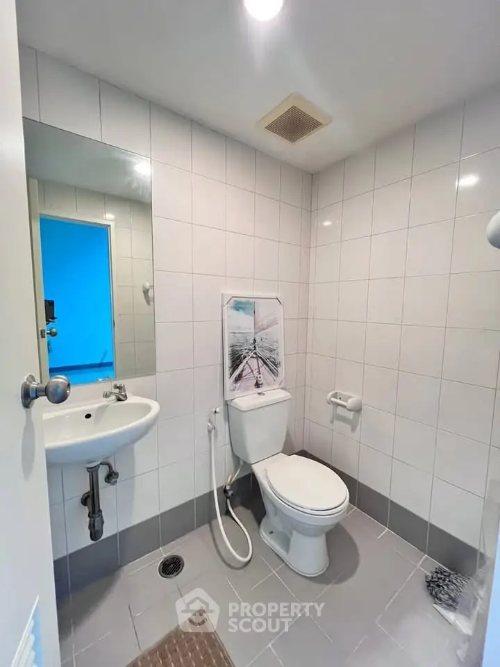 Modern bathroom with white tiles and sleek fixtures