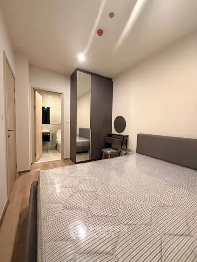 Modern bedroom with ensuite bathroom and sleek wardrobe design