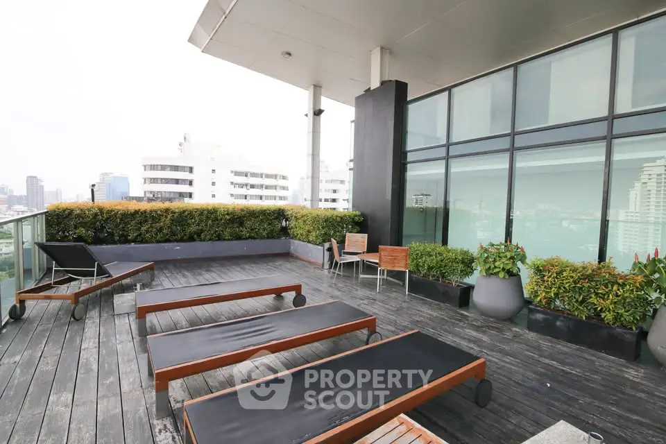 Luxurious rooftop terrace with modern lounge chairs and city view