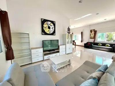 Spacious modern living room with stylish decor and ample natural light