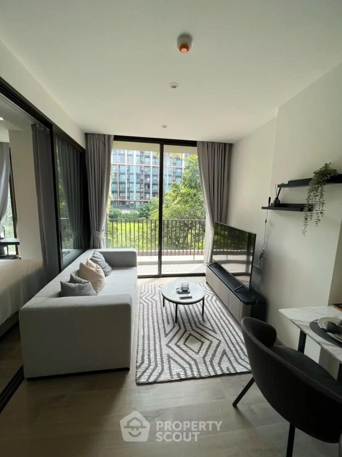 Modern living room with large windows and balcony view in stylish apartment