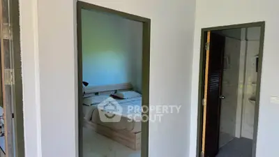 Cozy bedroom with adjacent bathroom in modern apartment