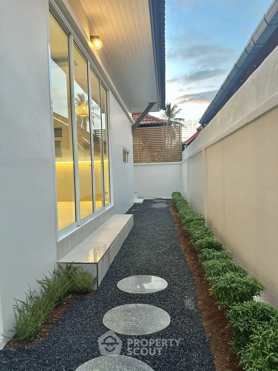 Modern exterior walkway with sleek design and garden landscaping