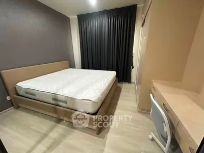 Modern bedroom with stylish furniture and cozy ambiance, featuring a comfortable bed and sleek desk area.