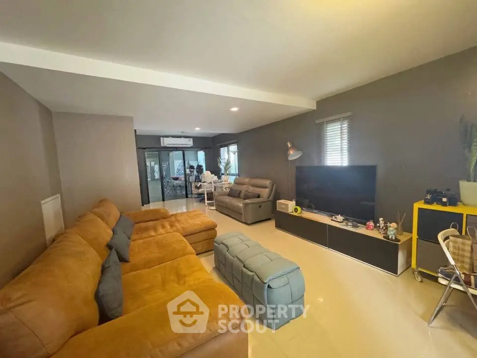 Spacious living room with modern furniture and entertainment setup