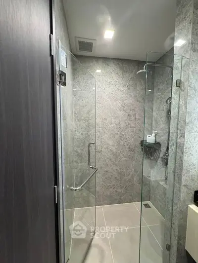 Modern bathroom with glass shower enclosure and sleek tile design