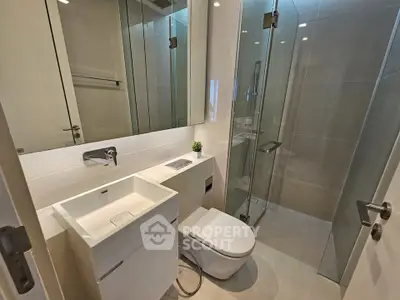 Modern bathroom with sleek fixtures and glass shower enclosure